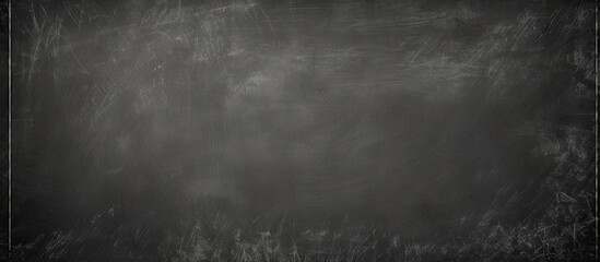 A blackboard with erased chalk marks serves as an abstract background ideal for adding text or graphics It embodies an education themed design with a copy space image