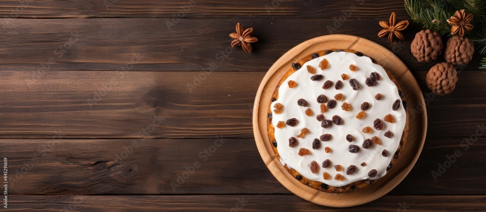 Aufkleber a close up view from above of a white glaze christmas cake with raisins placed on an old wooden cutt