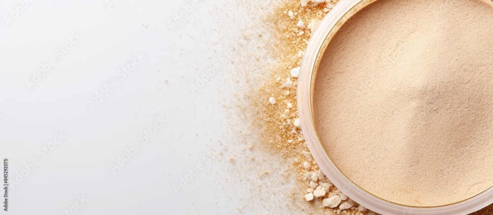 Leinwandbilder The image displays a circle of neutral colored face powder on a light background banner seen from a top view The powder is arranged in a flat position and there is ample space for a copy It is a high