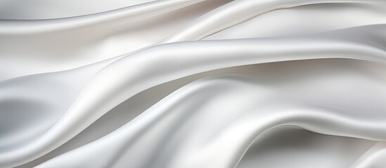 Obraz premium Smooth and soft white satin fabric creates an elegant and stylish backdrop The silky texture of the cloth adds to the beauty of this empty copy space image