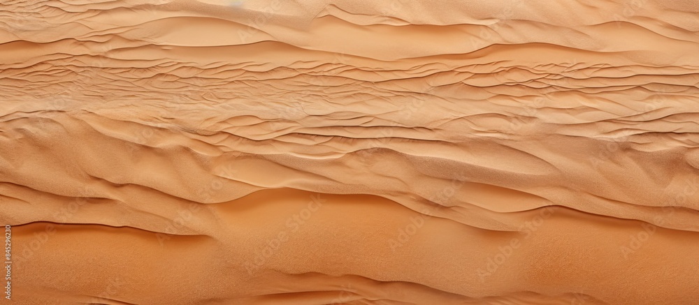 Poster a closeup top view of a natural sandy beach with a brown dry sand texture perfect for summer designs