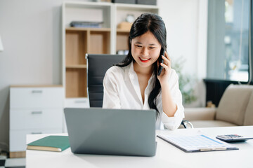 businesswoman working at office with laptop, tablet and taking notes on the paper..