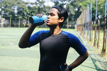 Young Asian Man Drinking Water Of Bottle After Running, Fitness And Healthy Lifestyle Concept.