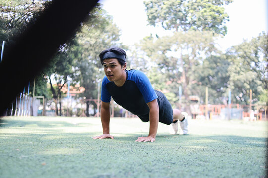 Strong Asian Man Making Strength Workout, Doing Push Up, Leading Active Lifestyle.