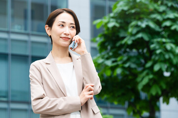 スマートフォンで通話している若い女性　ビジネスイメージ