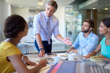 Group, talking and staff in meeting office for planning, ideas and collaboration support of project pitch. Men, woman and discussion for brainstorming, feedback or teamwork of negotiation goal