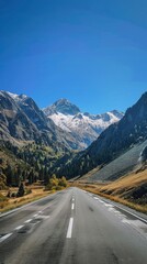 Naklejka premium Empty highway between mountain peaks, clear sunny day, incredible nature, bright saturated colors