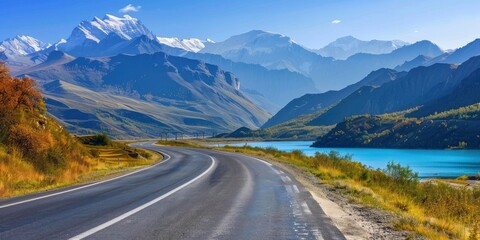 Empty highway between mountain peaks, lake in the gorge, clear sunny day, incredible nature, bright saturated colors
