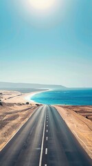 Fototapeta premium Empty highway, huge desert sand dunes on one side of the road and sea coast on the other, blue water, clear sunny day, bright rays, incredible nature