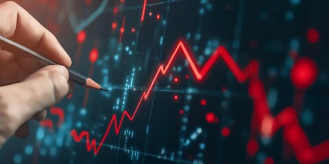 A hand sketches a chart with a red line on a digital display, representing meticulous financial plotting and the modern use of digital tools in business analytics.