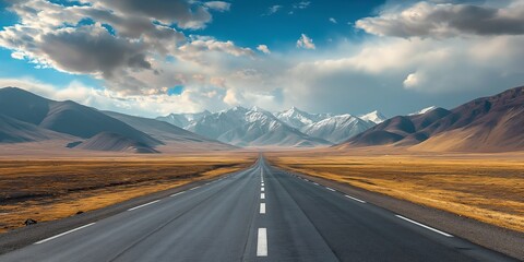 An expansive road leading into the distance captures your imagination amidst mountainous terrain and a sky filled with striking clouds, evoking a sense of adventure.