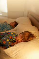 Children, bed and rest for night, sleeping and tired with fatigue and peace. Brothers, dreaming and...