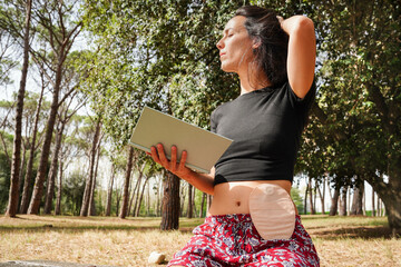 Relaxed young woman shows her belly with her ostomy bag