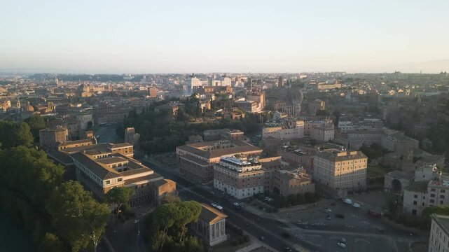 Panoramic aerial dolly rises above streets of Orange Garden neighborhood at sunset Italy