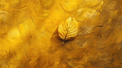 Shiny yellow leaf on a golden textured wall with gradient shadows Perfect for text space