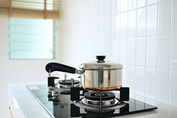 Stainless steel pot on gas stove. Household appliances concept