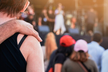 Music band playing on a summer music festival concert while the people listen