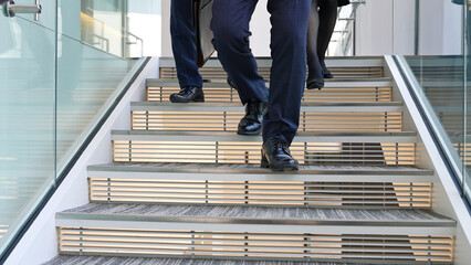 Group of business people walking up the stairs