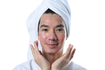 Young man applying moisturizer cream on skin. Rejuvenation and male skin care concept