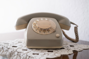 Old white Rotary Telephone with Disc Dial with finger, putting retro phone reciver down, hanging...