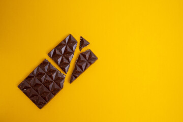Chocolate bar, top view on color background with copy space. Sweets and chocolate concept