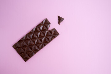 Chocolate bar, top view on color background with copy space. Sweets and chocolate concept