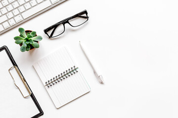 office desk design with notebook and glasses top view space for text
