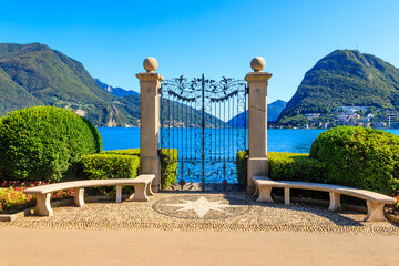 Old wrought iron gate overlooking Lake Lugano in Ciani Park, Lugano, Switzerland © olyasolod