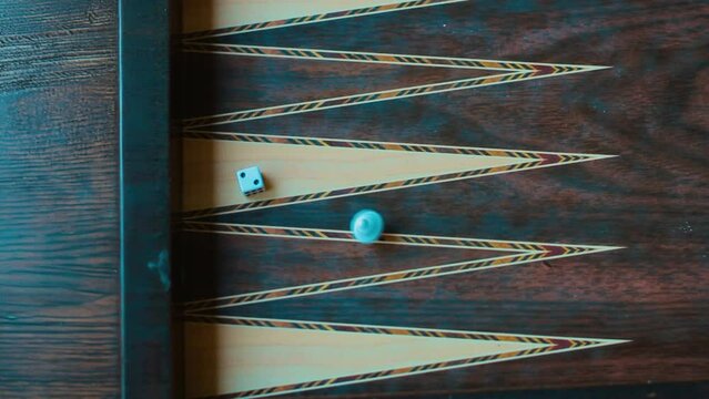 Close-up backgammon board with rolling dice 