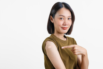Immunization for viral disease. Beautiful Asian woman showing shoulders after getting a vaccine....