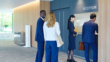Group of multinational business people walking and talking inside a building