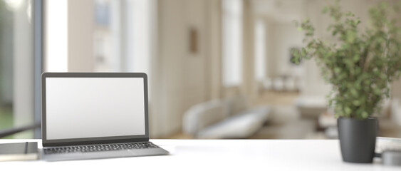 Computer laptop with blank screen on desk in modern office setting features clean workplace with technology laptop on table white background and digital business tools
