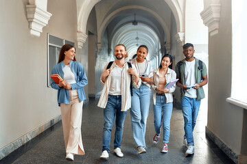 Students walking in university hallway, showing friendship, collaboration, academic pursuit