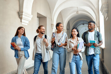 Students walking in university hallway, showing friendship, collaboration, academic pursuit