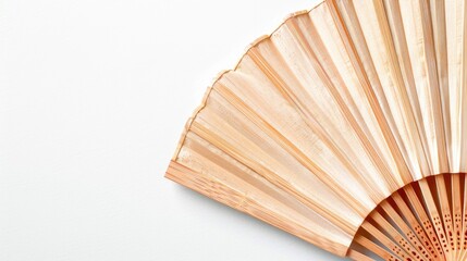 Wooden folding fans up close on white background top view with empty space