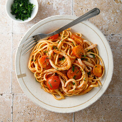 Homemade pasta with tomatoes and squid