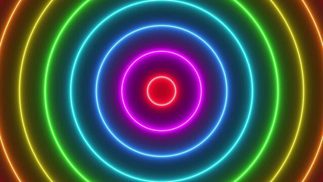 Looped animated background of concentric neon light circles with rainbow colors on black background