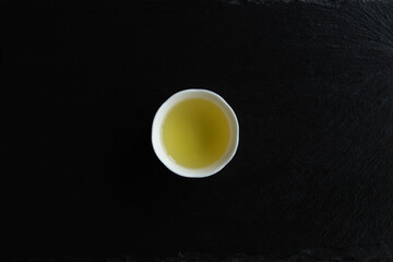 Japanese Green Tea in a beauty minimalist aesthetic arrangement on black granite board background. Japan.