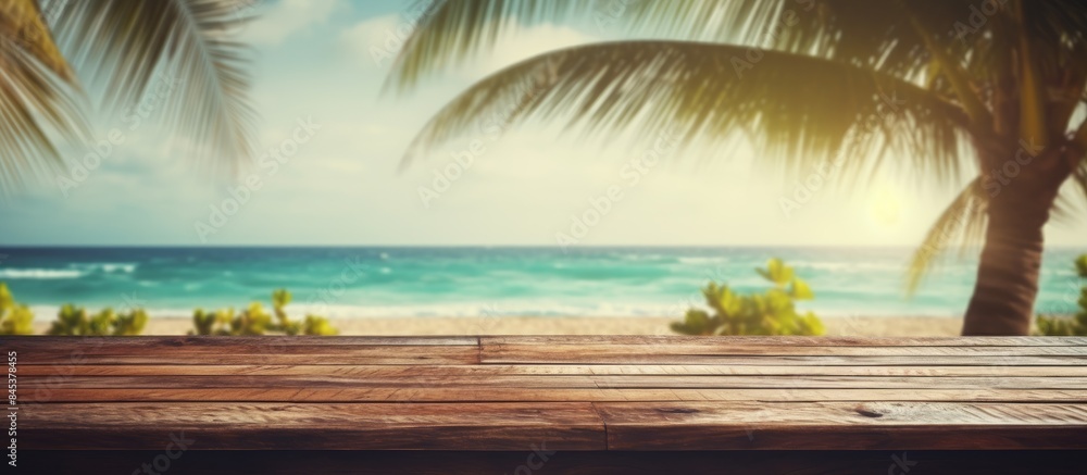 Poster Blur tropical beach with bokeh sun light wave and palm tree on copy space empty old wood table abstract background Product presentation in nature Vintage tone filter effect color style