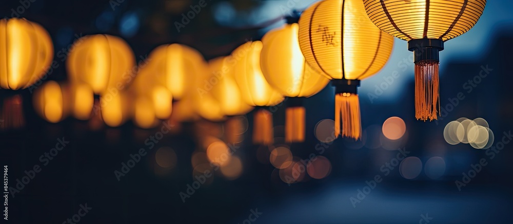 Aufkleber a row of yellow lanterns at night against a blurred background the subject is out of focus. creative