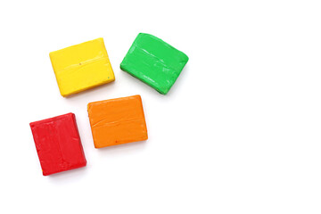 Colorful plasticine clay on white background.