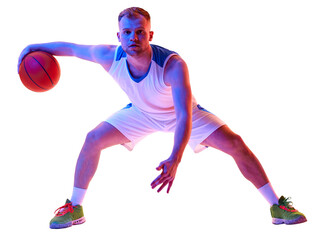 Young man, basketball player playing game, preparing for maneuver or shot in neon light against...