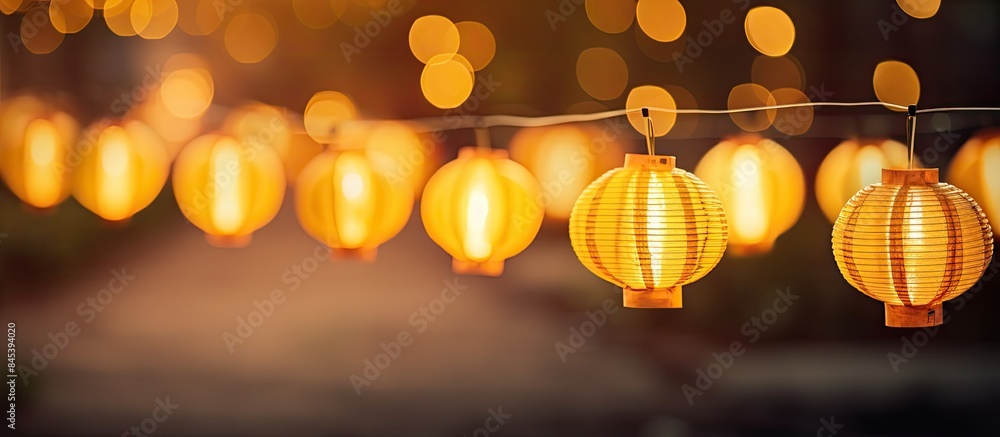 Aufkleber a row of yellow lanterns at night against a blurred background the subject is out of focus. creative