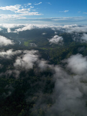 A high-angle landscape, dense fog, natural forest mountains covered in fog. A bright sky and beautiful landscape can be viewed from the sky with a drone.