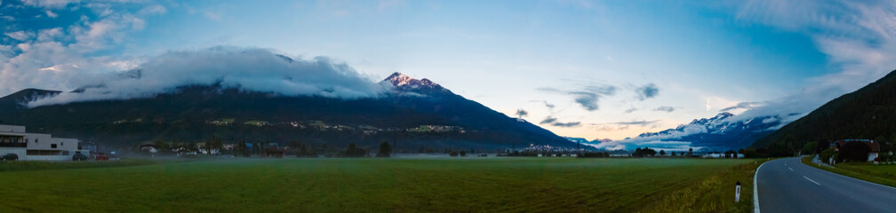 High resolution stitched alpine summer sunrise panorama with dramatic clouds at Pettnau, Innsbruck, Tyrol, Austria