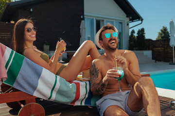 Couple relaxing by the poolside