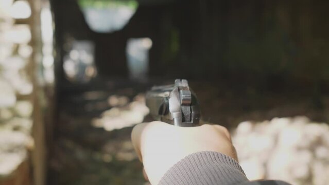 first person view Russian Makarov pistol shooting pneumatic training of Russian soldiers concept in the forest in summer or in an abandoned building