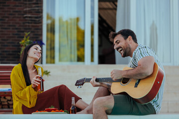 Man playing guitar for his girlfriend