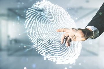 Multi exposure of programmer's hand working with virtual abstract fingerprint illustration on...