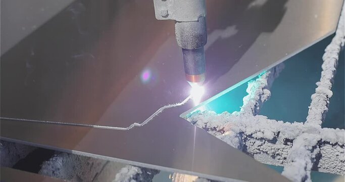 The plasma cutter will cut the part. The process of cutting a metal part with a plasma cutter. Plasma cutting Plasma cutter work at the factory.